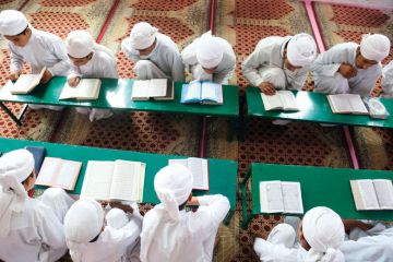 Students recite the holy Koran to illustrate Taliban begins religious reform of Afghan universities