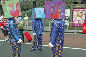 A group of performers cover their heads with boxes in Sydney, Australia to illustrate Excessive secrecy ‘undermining security’ of Australian research