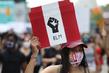 Protester holds  Black Lives Matter banner