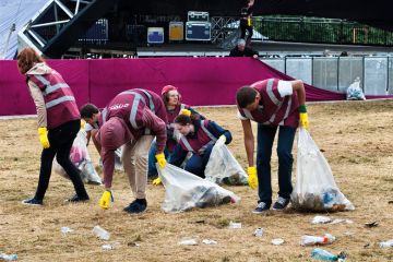  A team of litter pickers clearing up the morning after a music festival - Wilderness, Cornbury, Oxfordshire, UK to illustrate Time to bin all REF open access rules, say Oxford research chiefs