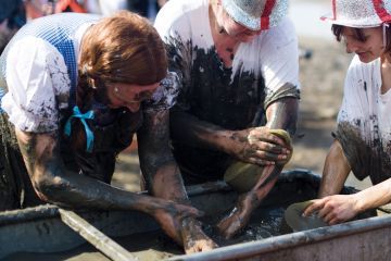 Participants try to wash some of the mud away at the end of the annual Maldon Mud Race in Maldon, Essex to illustrate Bid to cut grant administrative burden ‘may have opposite effect’