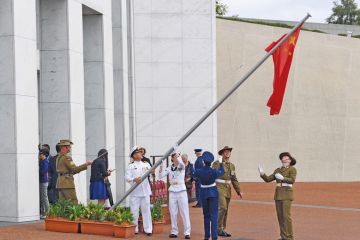 Australian soldiers lower a Chinese flag to get it untangled outside the Parliament House in Canberra to illustrate Chinese students ‘turned off Australia’ by visa crackdown