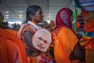 Supporters of the Bharatiya Janata Party (BJP) gather to hear India's Prime Minister Narendra Modi speak to illustrate Is Modi’s electoral setback  a win for Indian HE?