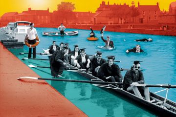 Graduates in rowing boat with people in suits in the water