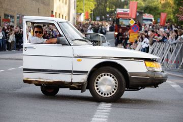 Person giving a performance in half a car