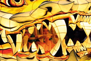 Men are pictured inside the mouth of a float as South Korean Buddhists parade to illustrate Low-scoring students penalise instructors despite grade inflation
