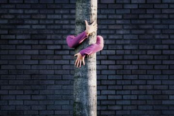 Woman hugging tree trunk