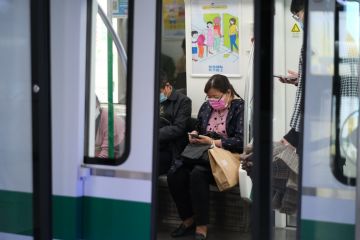 Wuhan China-Oct 2020 passengers in face mask to prevent coronavirus, sitting inside subway train in Wuhan