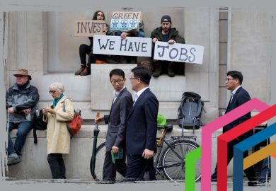 Asian businessmen look at environmental activists protesting about Climate Change during the blockade outside the Bank of England in the heart of the capital's financial district