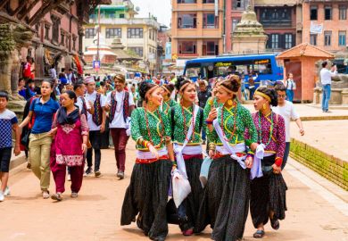 Group of dancers wearing traditional costumes in Patan Durbar Square, Kathmandu Valley,