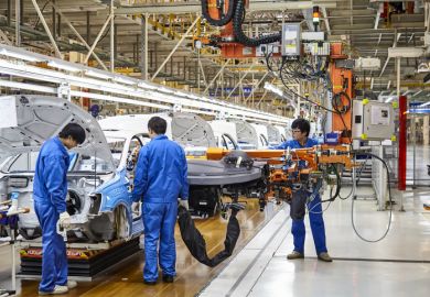 Workers install cars on the Shanghai Volkswagen factory assembly line.