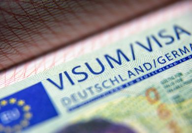 German visa stamp in passport close-up.