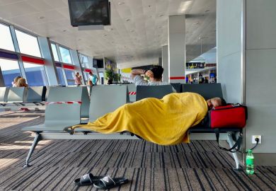 Kiev Ukraine-July 2021: A tired man sleeps on a bench at the airport while waiting for his transit flight.