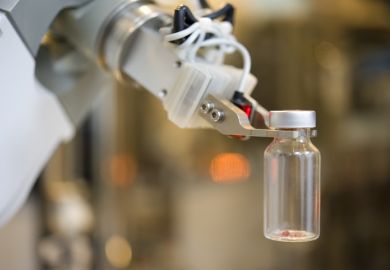 Robot hand picks up glass bottle in lab