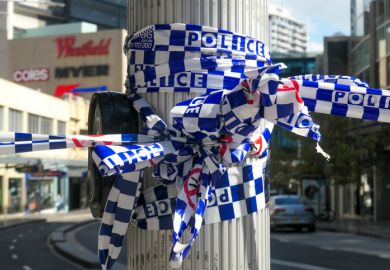 NSW Police cordon tape wrapped around a light pole. This image was taken at the corner of Oxford Street and Hollywood Avenue, Bondi Junction