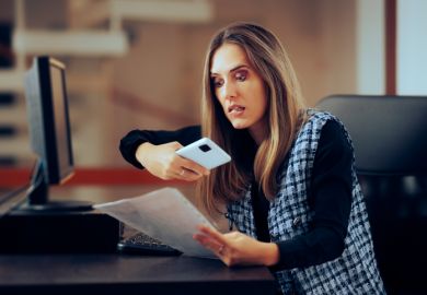 A woman photographs someone's essay, symbolising plagiarism