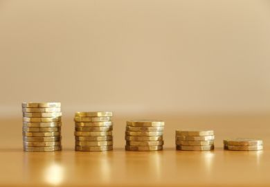 Shrinking piles of pound coins, symbolising financial stress