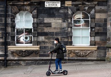 Student on a scooter on campus at the University of Glasgow, with large eyes looking at him through windows. To illustrate the university being placed on a student visa sponsorship “action plan” by the Home Office