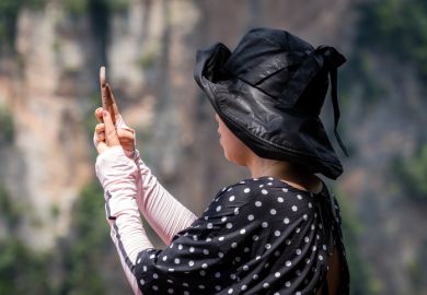 Tourist taking selfies in Zhangjiajie Tianzi lookout