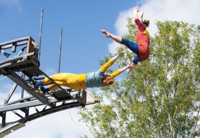 Performers launch themselves off the Imagineer Bridge in Warwick to illustrate ‘Contagion’ risk if UK university goes under, warns report