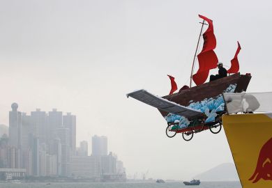 A participant sits in his structure that features a traditional Chinese fishing boat at the Red Bull Flugtag (flight day) competition on a cloudy day in Hong Kong to illustrate Opaque investigation fails to clear clouds over HKU council