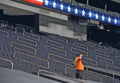  A security guard salutes while standing among empty seatsin Las Vegas, Nevada to illustrate US universities fear ‘ghosting’ by international students