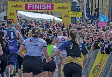 Runners holding hands approach the finish line at the London Landmarks Half Marathon 2024 to illustrate record numbers are getting clearing for university admissions