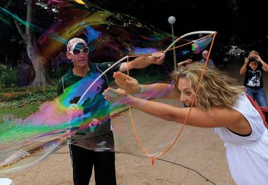 A volunteer puts her arms and head into one of the bubbles in Sydney's Hyde Park