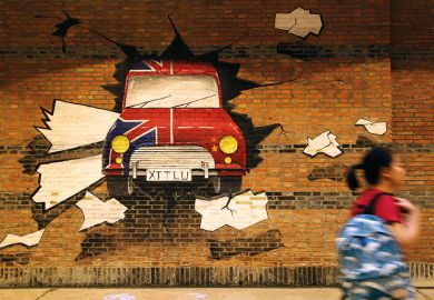 A student passes by an underpass with mural paintings at Xi'an Jiaotong Liverpool University in Suzhou, Jiangsu Province of China. Illustrates how China’s joint ventures with foreign universities could remain