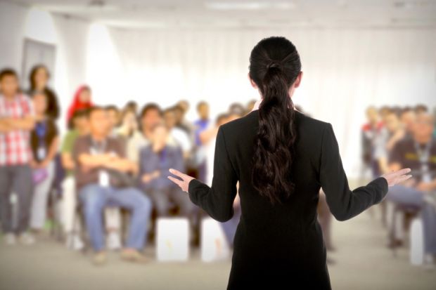 A female speaker addressing a conference