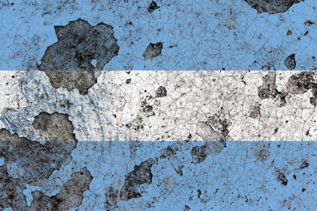 An Argentina flag on a damaged old concrete wall