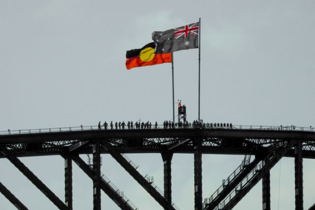 The Australian and Australian Aboriginal flags fly on the Sydney Harbour Bridge