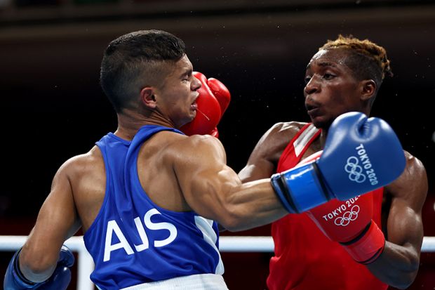 Patrick Chinyemba (R) of Zambia exchanges punches with Alex Winwood of Australia, boxing at the Tokyo 2020 Olympic Games. To illustrate that Australian universities face a bruising election.