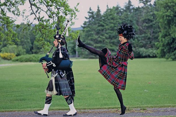 Woman behind man playing bagpipes