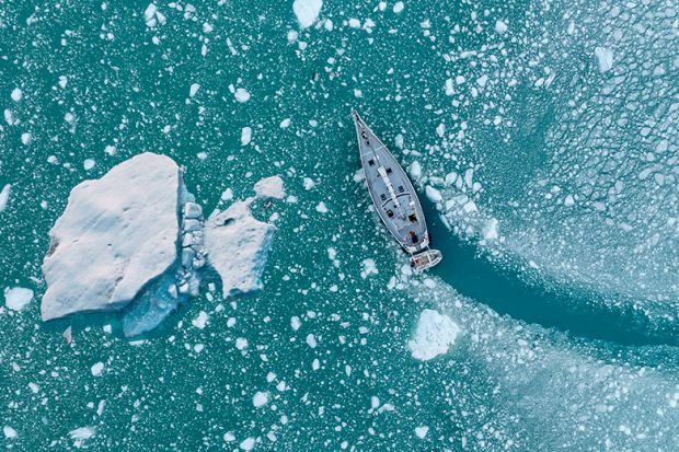 Boat changing course to avoid iceberg, illustrating scientific course correction.