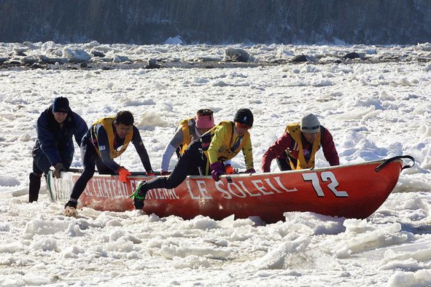 A team from Japan take part in a canoe race on ice, Quebec, illustrating that new international student caps hurt Quebec universities.