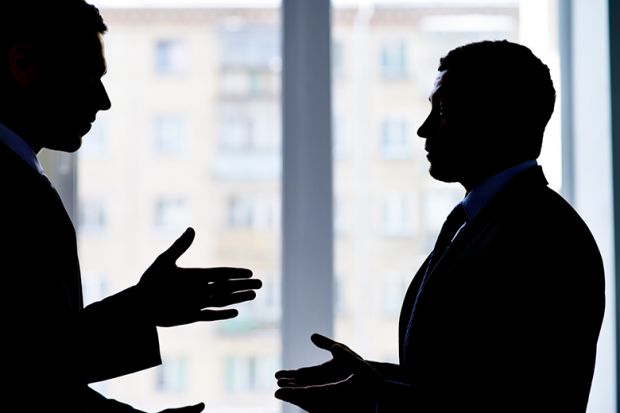 2 people having a dispute in an office. To illustrate bullying at UKRI.