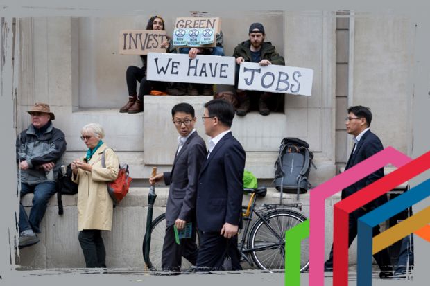 Asian businessmen look at environmental activists protesting about Climate Change during the blockade outside the Bank of England in the heart of the capital's financial district