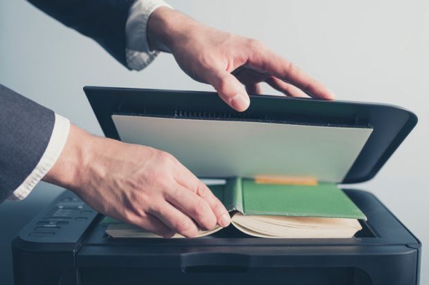 Man photocopying a book