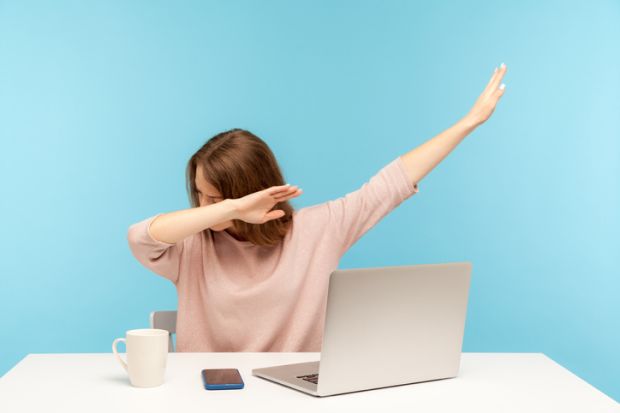 A woman watching a computer and doing a dab dance, symbolising online learning