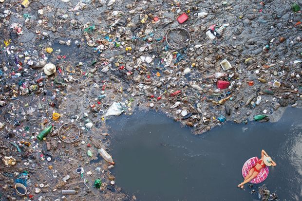 Montage of woman floating in sea of rubbish