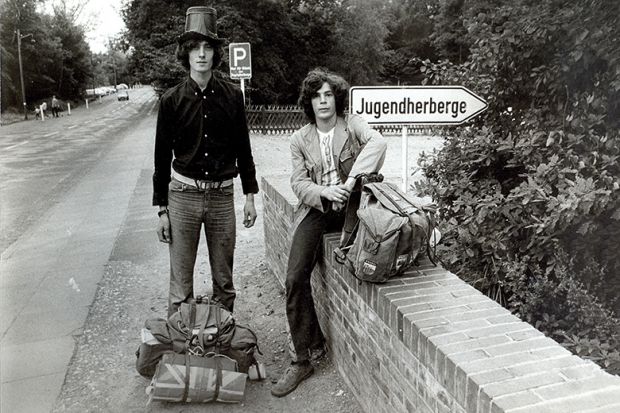 Two young men heading to a festival