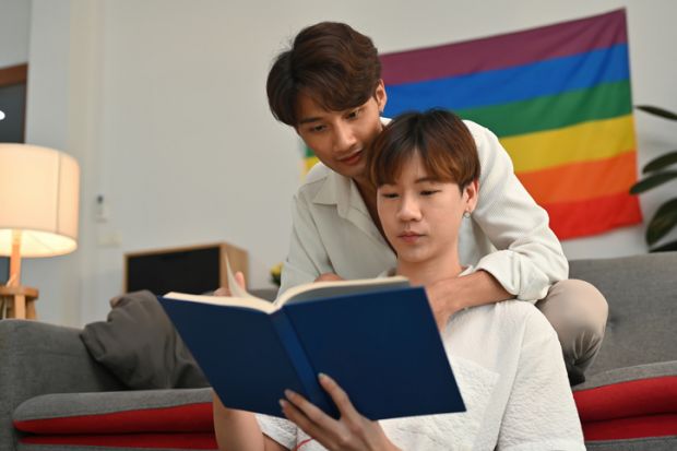 Gay students reading a book