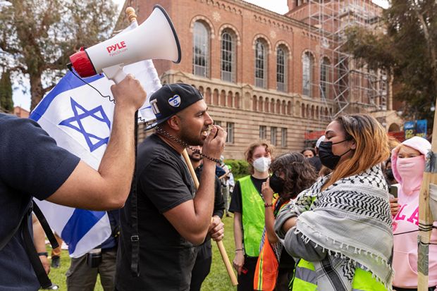 An Israeli man, holding a flag, argues with a pro-Palestinian student as pro-Palestinian students gather to protest against Israeli attacks on Gaza at University of California (UCLA) in Los Angeles, California, United States on April 25, 2024