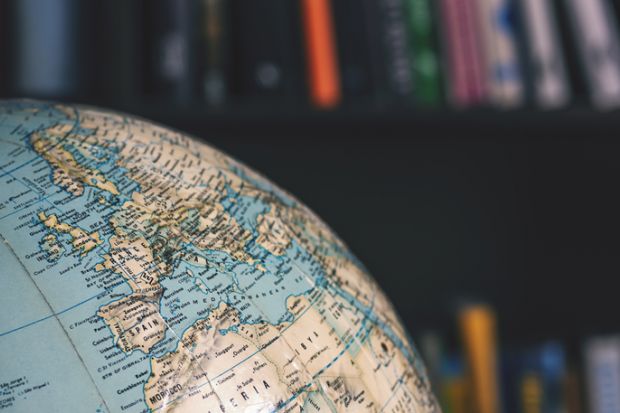 a globe with books in the background