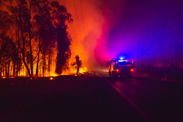 Green wattle creek fire impacted the village of Buxton, NSW, Australia. During December 18, 2019 Under strong winds and extreme temperatures. Fire truck passing fire front wilson drive.