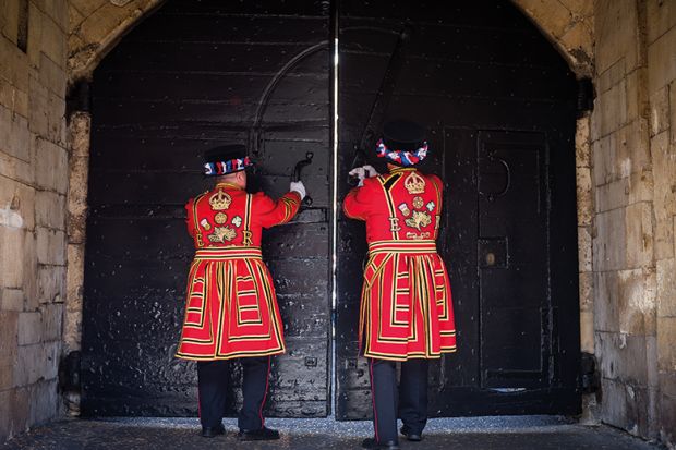 Two Yeoman Warders closing doors to illustrate whether Labour want more people to go to university