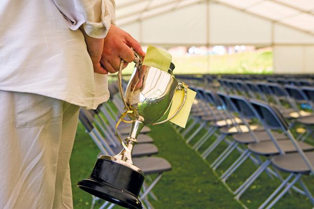 Holding a prize cup