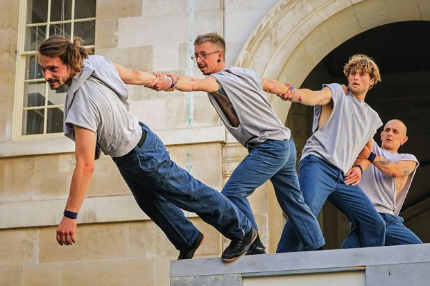 Four people holding on to each other