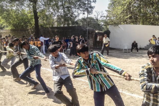 Young teenagers playing The game Tug of the war during Khel Maha Kumbh.